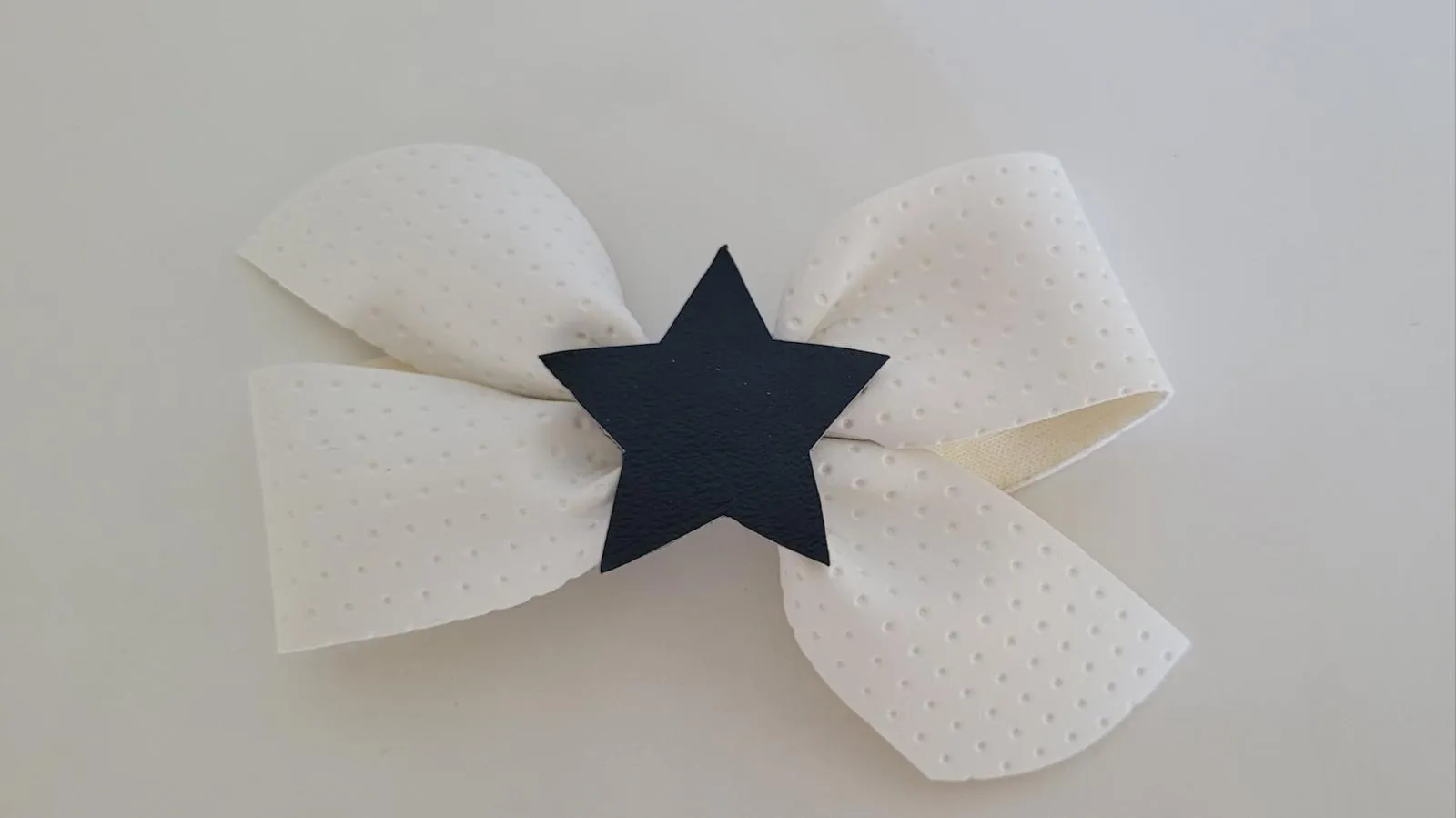 White vinyl bow with navy star